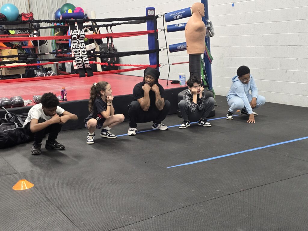 Students practice the duck walk